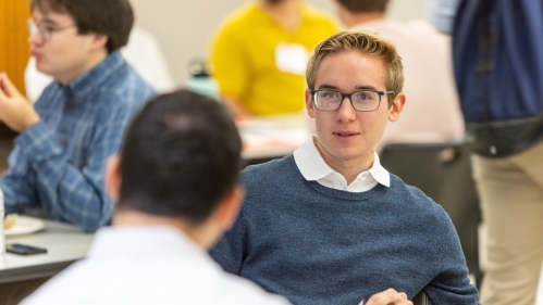 Student speaking to other student in class
