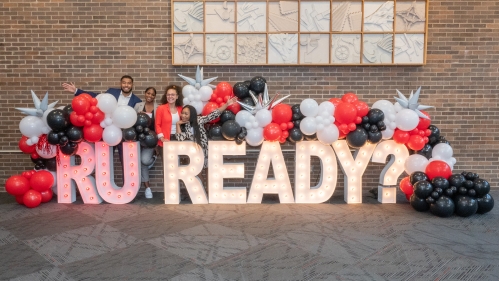 Students standing behind large RU Ready? sign and balloons