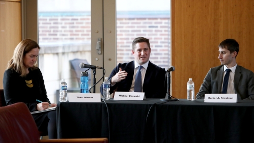 Legal professionals interact at a table during a training seminar at Rutgers Law School.