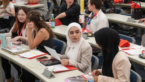 New students examine and discuss welcome packet materials at the Rutgers Law School orientation in Fall 2023.