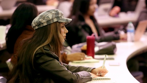 A young woman takes note while attending class at Rutgers Law School.