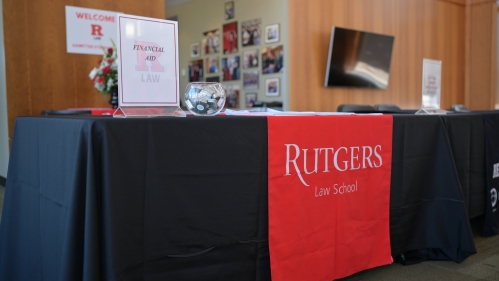Financial Aid sign on table with Rutgers Law School banner
