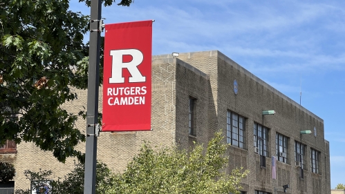 Banner under a blue sky on the Camden campus