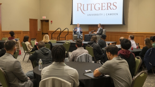 A large group attends a lecture at Rutgers Law School by a guest speaker.
