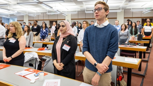 New students stand at a desk during Rutgers Law orientation programming.