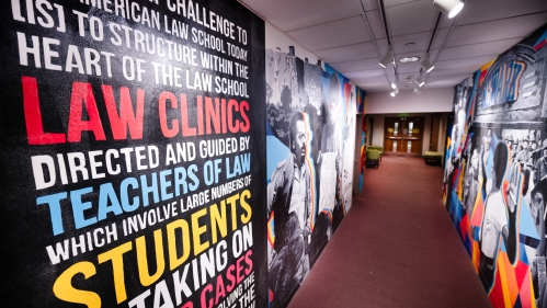 colorful mural in hallway with images and text 
