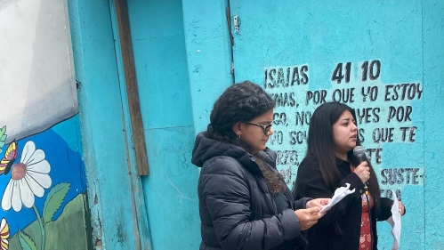 two women speaking at mic outside