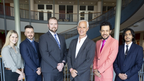 Lawyers in suits in group photo smiling