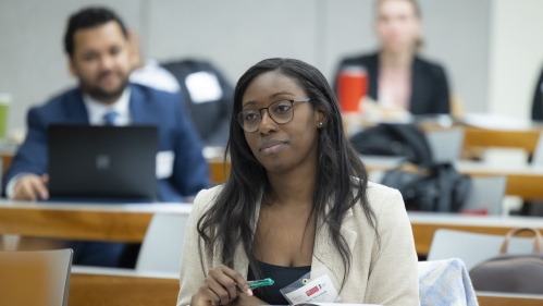woman at desk in classroom with booklet open