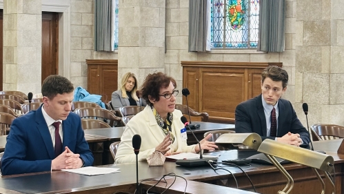 Ruth Anne Robbins provides testimony alongside two colleagues in a courtroom.