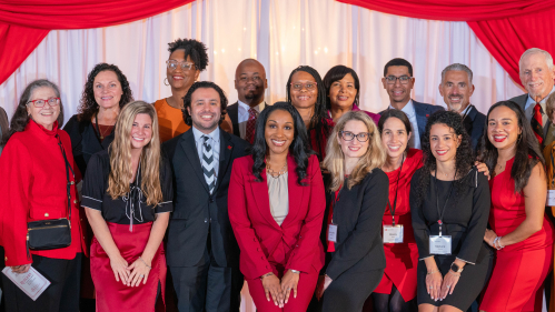 men and women standing next to each other on stage