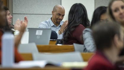 Man receiving applause in symposium