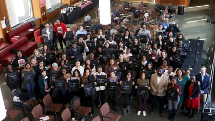  Group of students standing holding bags  
