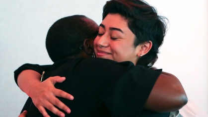 Woman hugging woman