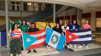 Students holding up flags of Latin America
