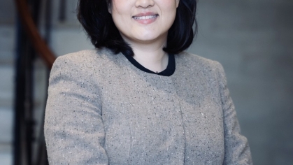 woman smiling with hand on dresser