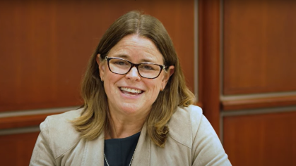 woman wearing glasses and smiling