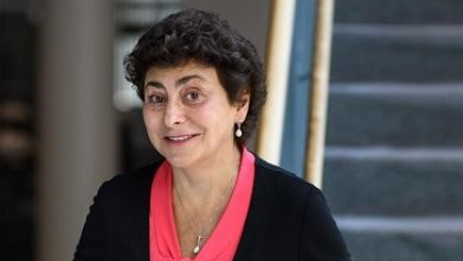 woman smiling with staircase behind her
