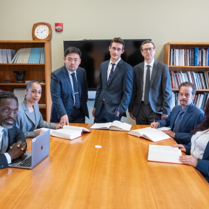 Young lawyers gathered around conference room table