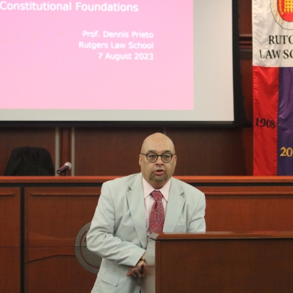Professor speaking at lectern 