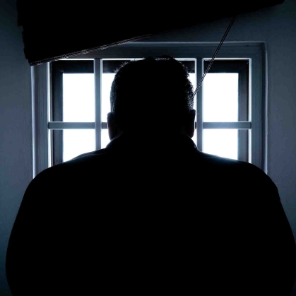 Silhouette of man in prison