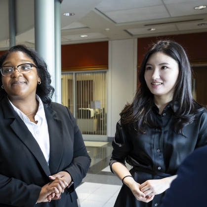 two women standing and looking off camera