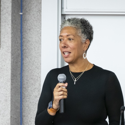 Woman speaking on mic at podium