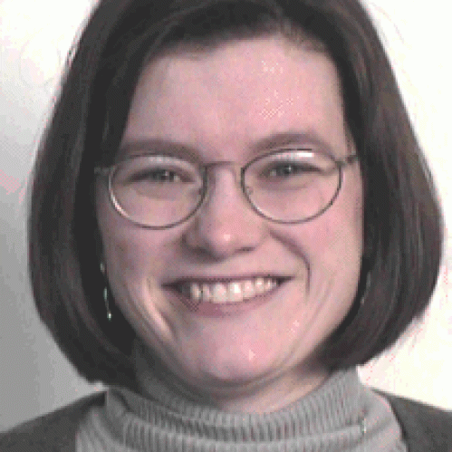 a woman with glasses smiling