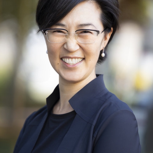 a woman with glasses smiling