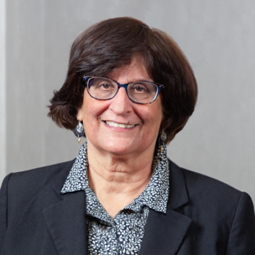 a woman with glasses smiling