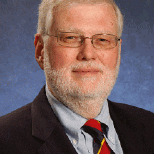 a man with a beard and glasses smiling