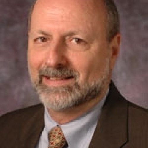 a man with a beard smiling