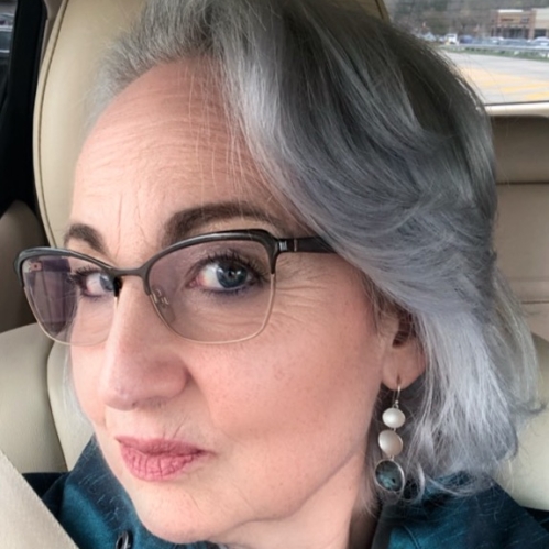 woman wearing glasses and smizing