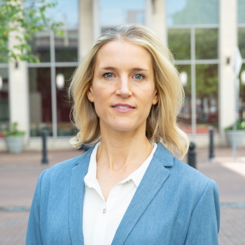 woman in blue blazer standing outside