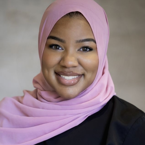 woman in pink head covering smiling