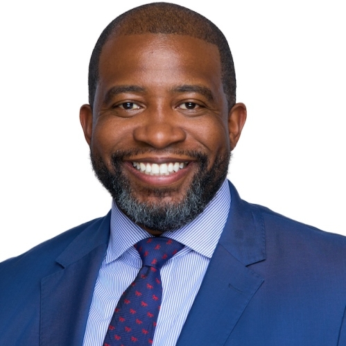 Man in blue suit and tie smiling