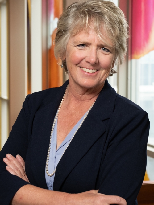 woman with folded arms smiling