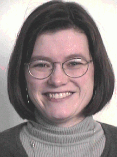 a woman with glasses smiling