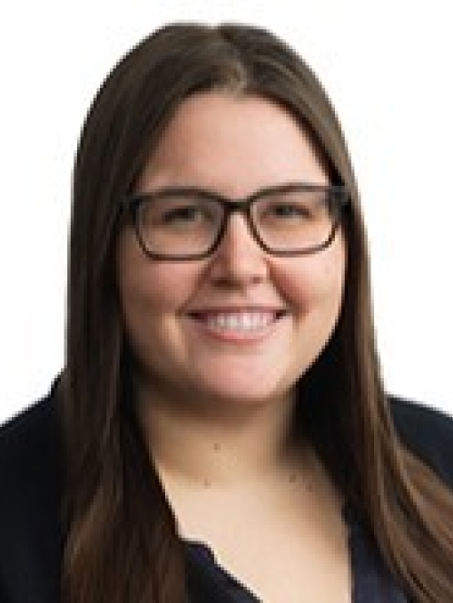 a woman with glasses smiling