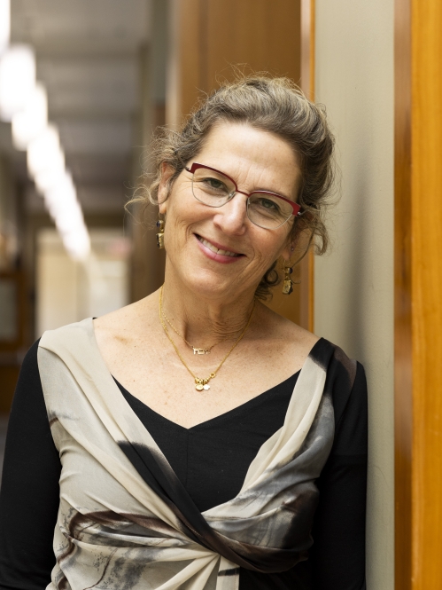 a woman with glasses smiling