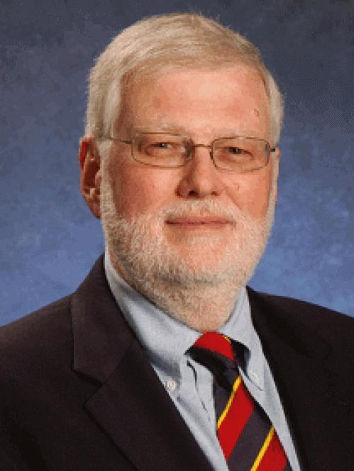 a man with a beard and glasses smiling