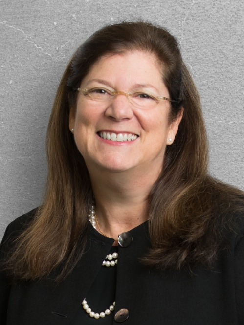 a woman with glasses smiling