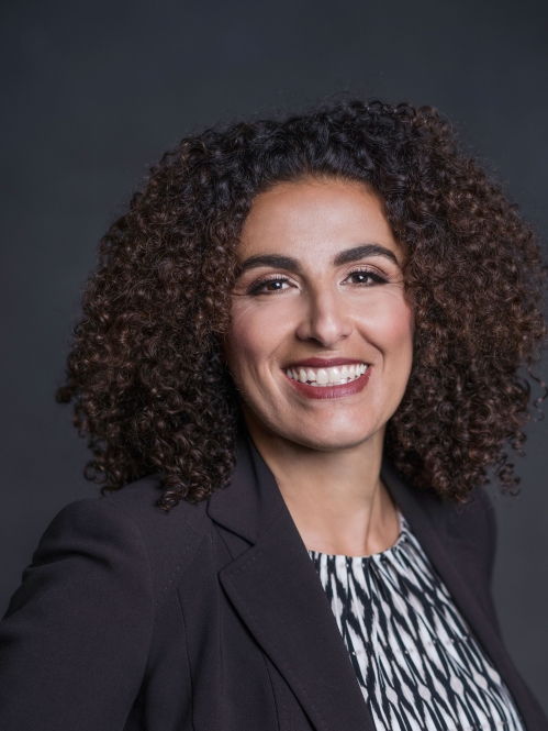 a woman with curly hair smiling