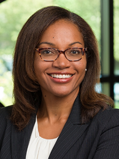 a woman with glasses smiling