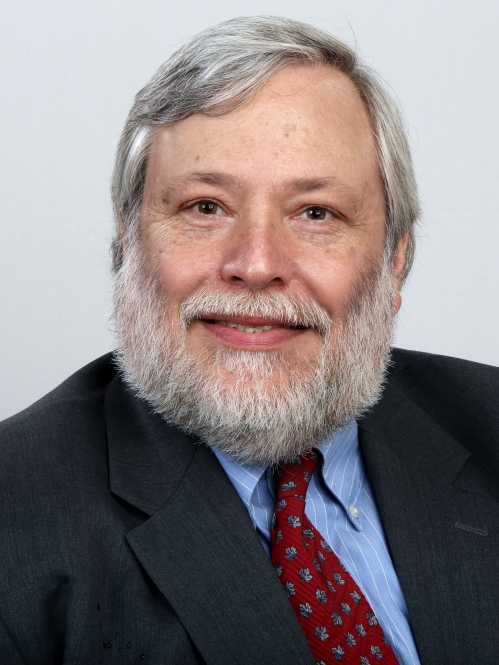 a man with a beard smiling