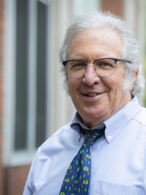 man in glasses, shirt and tie smiling