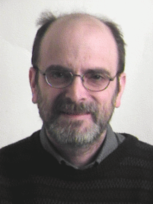 Man grinning with glasses wearing black sweater
