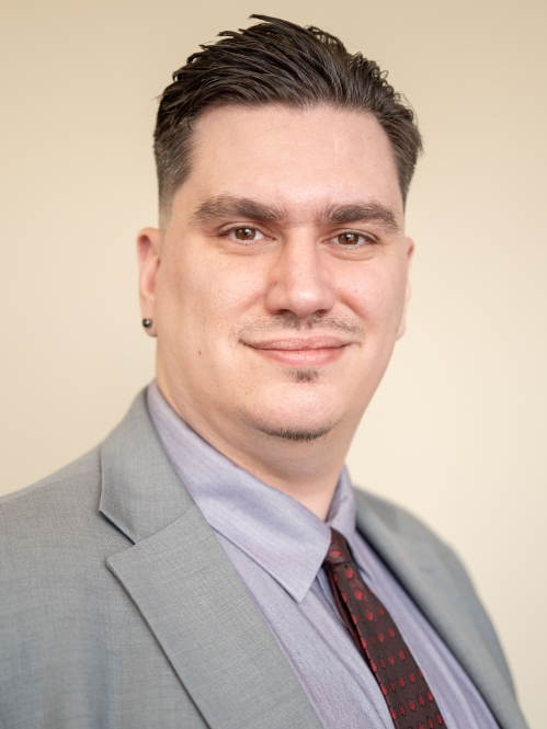 man in grey suit smiling