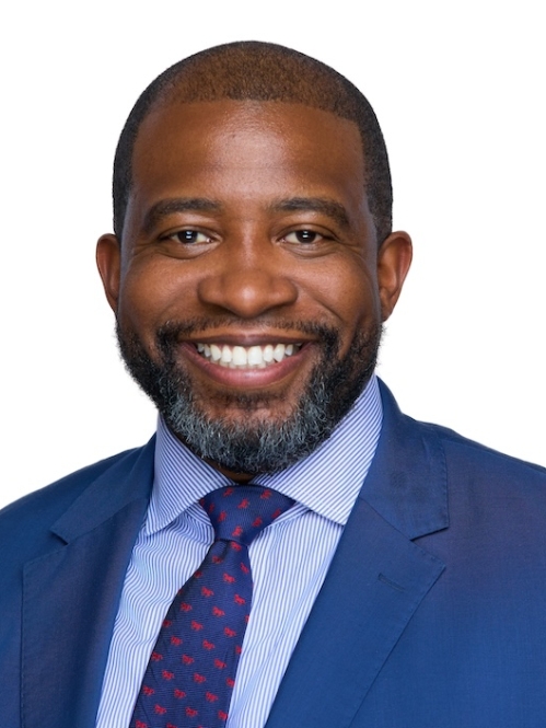 Man in blue suit and tie smiling