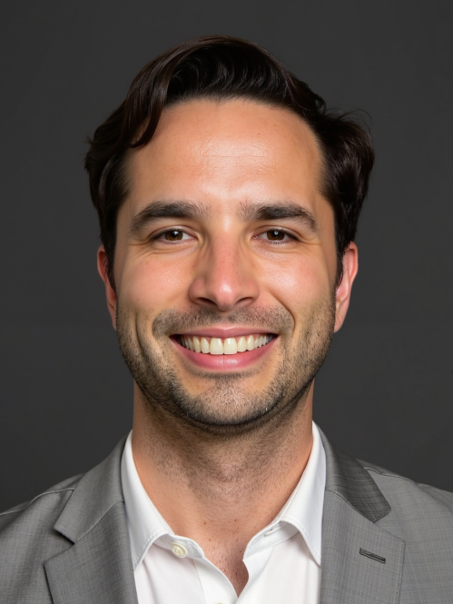 man in grey suit and white shirt smiling